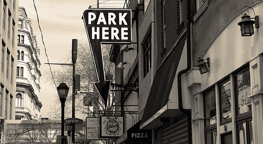 traditional parking sign in Philly, with an arrow and the words Park Here