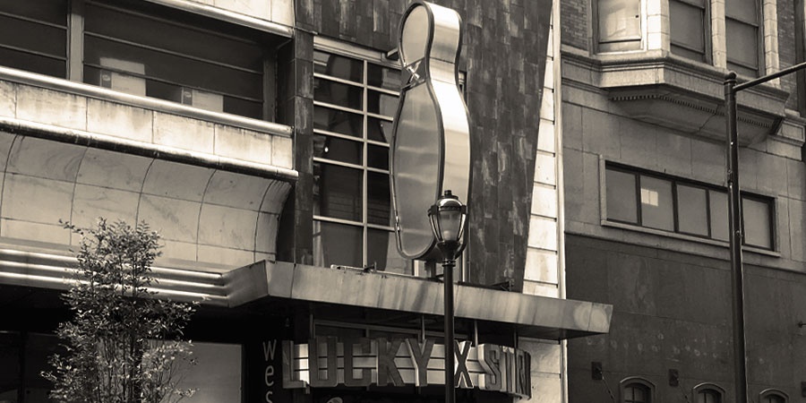 photograph of the exterior signage for Lucky Strike, which is shaped like a bowling pin.